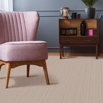 textured beige carpets in a living area with pink chair